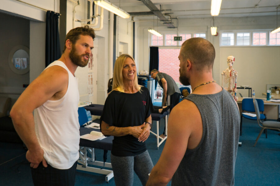 Rachel and wo men discuss a biomechanics workshop - in a learning setting.